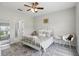 Cozy bedroom with neutral tones, decorative rug, and access to the en-suite bathroom at 267 Williamson Dr, Davenport, FL 33897