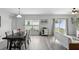 Bright dining area featuring wood-look floors, large windows, and seamless flow to the living area at 267 Williamson Dr, Davenport, FL 33897
