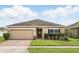 Inviting single-story home with well-maintained lawn, landscaping and two car garage at 267 Williamson Dr, Davenport, FL 33897