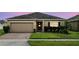 Charming single-story home with brick driveway and manicured lawn and a two car garage at 267 Williamson Dr, Davenport, FL 33897