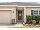 Inviting entryway with stylish front door, manicured landscaping, and brick-paved walkway at 267 Williamson Dr, Davenport, FL 33897