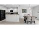 Bright kitchen features white cabinets, black appliances, and a view of the dining area at 267 Williamson Dr, Davenport, FL 33897