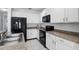 Well-equipped kitchen with white cabinets, black appliances, and granite countertops at 267 Williamson Dr, Davenport, FL 33897