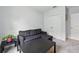 Living room with a gray sofa, black coffee table, and access to a closet and another room at 267 Williamson Dr, Davenport, FL 33897