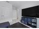 Living room boasting a large TV, storage units, and a view into the hallway at 267 Williamson Dr, Davenport, FL 33897