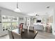 Inviting living room with lots of natural light, view of the dining area, and neutral décor at 267 Williamson Dr, Davenport, FL 33897
