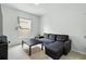 Cozy living room featuring a gray sofa, black coffee table, and a bright window at 267 Williamson Dr, Davenport, FL 33897