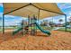 This playground offers slides and climbing structures under a shaded canopy at 267 Williamson Dr, Davenport, FL 33897