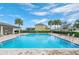 The neighborhood pool features palm trees, lounge chairs, and a covered seating area at 267 Williamson Dr, Davenport, FL 33897