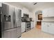 Well-equipped kitchen featuring stainless steel appliances and white cabinetry providing modern functionality at 2696 Clearview St, Clermont, FL 34711