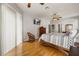 Tranquil main bedroom with wood floors, a ceiling fan, and sliding glass doors for natural light at 2696 Clearview St, Clermont, FL 34711