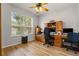 Bright home office features wood floors, built-in cabinets, and a large window with natural light at 2696 Clearview St, Clermont, FL 34711