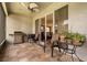Relaxing screened patio with tile flooring, ceiling fan, grill, and comfortable seating at 2696 Clearview St, Clermont, FL 34711