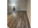 Spacious bedroom with wood-look flooring and a minimalist aesthetic at 2776 Curry Ford Rd # Ge, Orlando, FL 32806