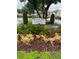Well-manicured flower garden surrounding the Orange Tree Village Condominiums sign at 2776 Curry Ford Rd # Ge, Orlando, FL 32806