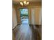 Dining space with sliding glass doors to patio and wood-look flooring at 2776 Curry Ford Rd # Ge, Orlando, FL 32806