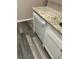 Modern white dishwasher with granite countertop and gray wood-look flooring at 2776 Curry Ford Rd # Ge, Orlando, FL 32806