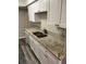 Bright kitchen with white cabinets, granite counters, stainless sink, and new flooring at 2776 Curry Ford Rd # Ge, Orlando, FL 32806