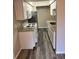 Efficient white kitchen with stainless steel appliances and granite countertops at 2776 Curry Ford Rd # Ge, Orlando, FL 32806