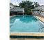 Community pool with clear water and surrounding greenery at 2776 Curry Ford Rd # Ge, Orlando, FL 32806
