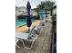 Community pool area with lounge chairs and umbrellas, perfect for relaxation at 2776 Curry Ford Rd # Ge, Orlando, FL 32806