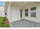 Cozy back porch area with stone pavers and neutral exterior, perfect for relaxing outdoors at 2926 Sailhouse Drive, St Cloud, FL 34771