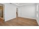 Neutral bedroom with hardwood floors and view of bath featuring glass-enclosed shower at 2926 Sailhouse Drive, St Cloud, FL 34771