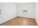 Bright bedroom features hardwood floors and a large window with a neighborhood view at 2926 Sailhouse Drive, St Cloud, FL 34771