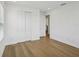 Bright bedroom features wood floors, a large window, and closet with paneled doors at 2926 Sailhouse Drive, St Cloud, FL 34771