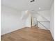 Bonus room includes wood floors, staircase and adjoining hallway leading to bathroom at 2926 Sailhouse Drive, St Cloud, FL 34771