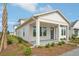Stylish home showcasing a covered porch, modern design, and fresh landscaping, perfect for welcoming guests and enjoying outdoor living at 2926 Sailhouse Drive, St Cloud, FL 34771