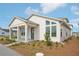 Inviting single-Gathering home with a covered porch, accentuated by well-maintained landscaping and a modern aesthetic at 2926 Sailhouse Drive, St Cloud, FL 34771