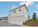 Home exterior featuring a two-car garage, light-toned siding, and well-kept landscaping for a tidy appearance at 2926 Sailhouse Drive, St Cloud, FL 34771