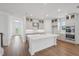 Open concept kitchen with an oversized island, stainless appliances and hardwood flooring at 2926 Sailhouse Drive, St Cloud, FL 34771