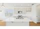 Modern kitchen features a large island with sink, white cabinetry, and stainless appliances at 2926 Sailhouse Drive, St Cloud, FL 34771