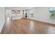 Open-concept living space featuring hardwood floors, flowing into a modern kitchen with an island, perfect for entertaining at 2926 Sailhouse Drive, St Cloud, FL 34771
