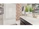 Bright bathroom with a tub, vanity, quartz countertop, and decorative plants at 3005 Namaste Dr, Clermont, FL 34714