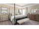 Spacious bedroom featuring a four-poster bed, stylish furnishings, and plenty of natural light at 3005 Namaste Dr, Clermont, FL 34714