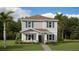 Charming two-story home with teal shutters and lush landscaping at 3005 Namaste Dr, Clermont, FL 34714