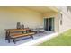 Covered patio features a dining table and seating area, perfect for outdoor entertaining at 3005 Namaste Dr, Clermont, FL 34714