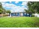 Blue home exterior with a spacious yard perfect for outdoor activities and relaxation at 3007 Knollwood Cir, Orlando, FL 32804