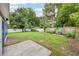 The backyard features a well-maintained lawn, fencing, and mature trees at 3007 Knollwood Cir, Orlando, FL 32804