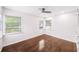 Bright bedroom featuring hardwood floors, a ceiling fan, and many windows at 3007 Knollwood Cir, Orlando, FL 32804