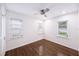 Bright bedroom with hardwood floors, neutral walls, ceiling fan, and natural lighting at 3007 Knollwood Cir, Orlando, FL 32804