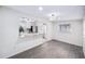 Open-concept dining room with modern lighting, gray flooring, and a view of the updated kitchen and living area at 3007 Knollwood Cir, Orlando, FL 32804