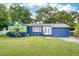 Charming blue single-story home with a well-maintained lawn and fresh landscaping at 3007 Knollwood Cir, Orlando, FL 32804