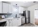 Updated kitchen features stainless steel appliances, modern countertops, and subway tile backsplash at 3007 Knollwood Cir, Orlando, FL 32804