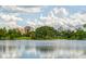 A serene lake reflecting the city skyline, framed by lush greenery at 3007 Knollwood Cir, Orlando, FL 32804