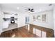 Bright living room featuring hardwood floors, modern ceiling fan, and an open view into the remodeled kitchen at 3007 Knollwood Cir, Orlando, FL 32804