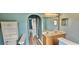 Bathroom with dual sinks, hard flooring, and vanity lighting, leading to other rooms at 3222 Reserve Ct, Orlando, FL 32825